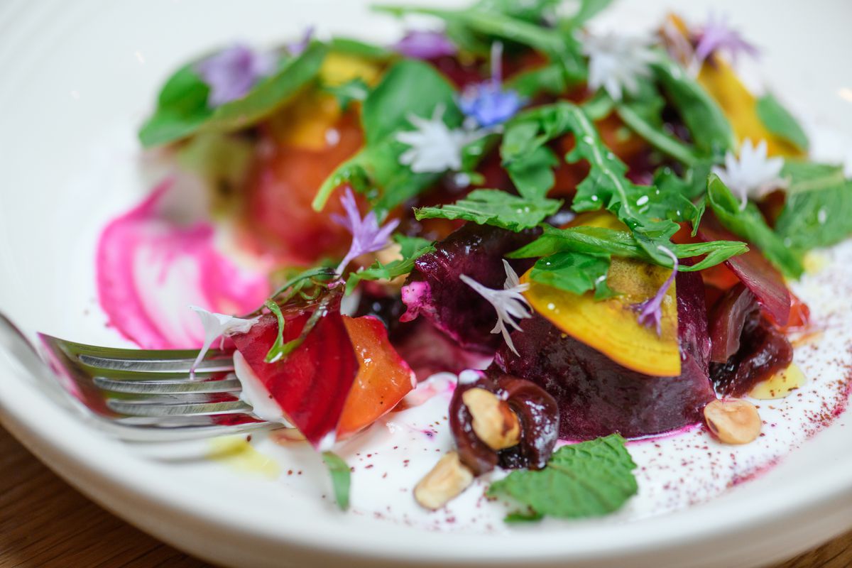 A beet salad arrives topped with herbs and chive blossoms at Humble Spirit in McMinnville, Oregon.