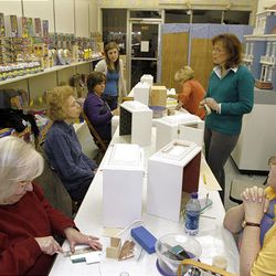 In this photo made on Feb. 4, 2010, Judy Mizikar, right in green, talks to the women gathered for a class she teaches at her shop in Greensburg, Pa.