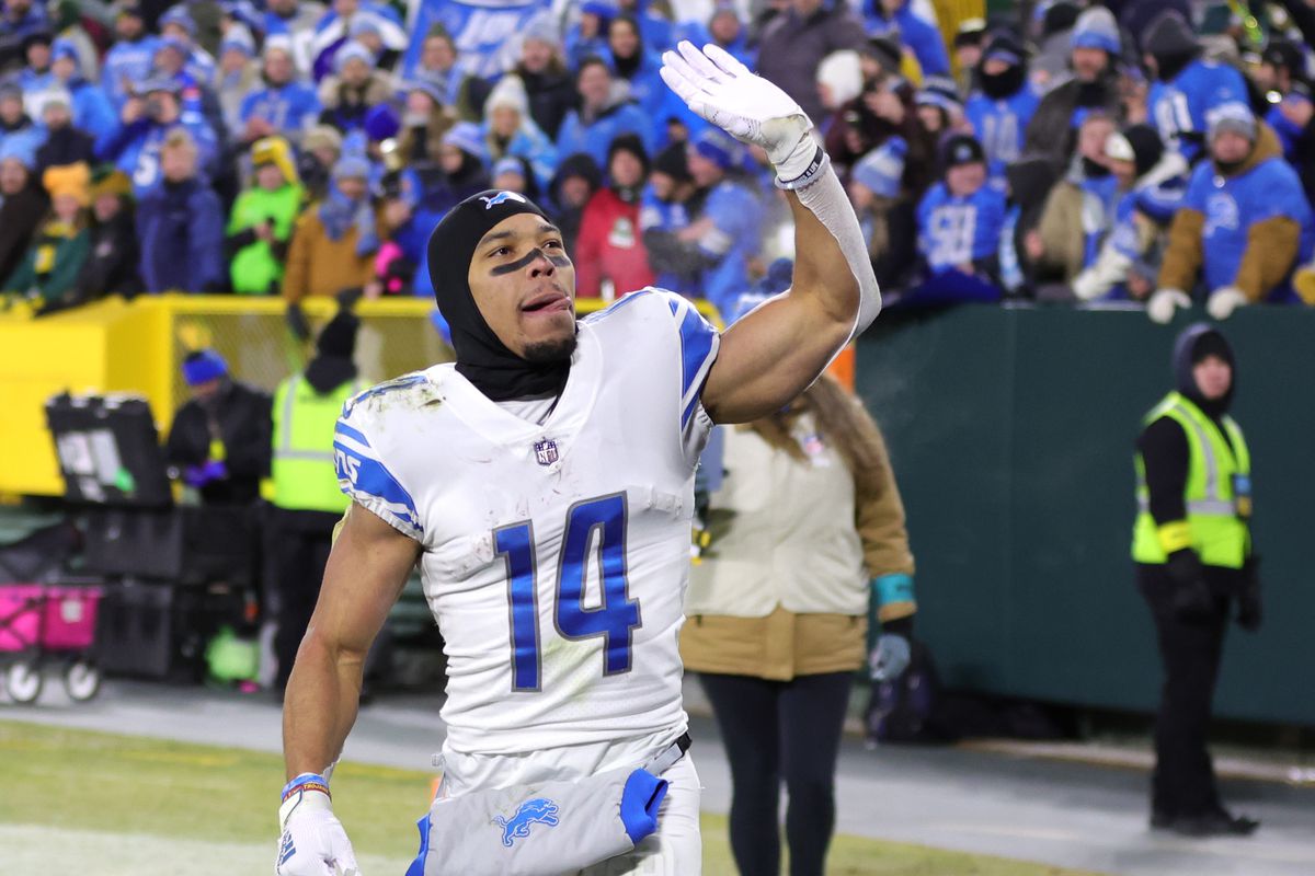 Amon-Ra St. Brown #14 of the Detroit Lions greets fans after defeating the Green Bay Packers at Lambeau Field on January 08, 2023 in Green Bay, Wisconsin.