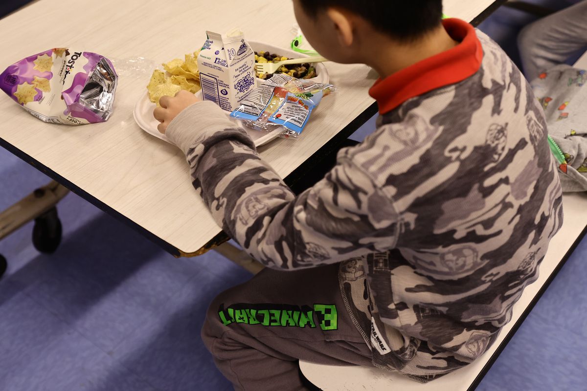 A student eats a vegan meal served for lunch (with milk as a drink) at Yung Wing School P.S. 124.