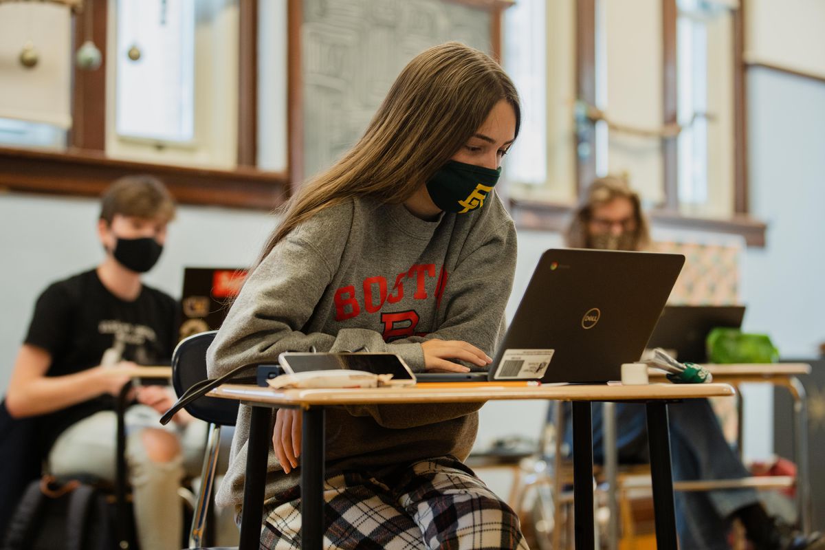 An IB History student looks at a laptop at Nicholas Senn High School in the Edgewater neighborhood, Friday afternoon, April 23, 2021. All students and staff, regardless of vaccination status, will be required to wear masks next school year.