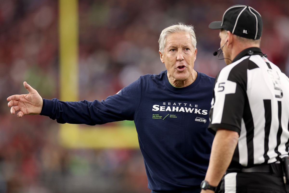 Seattle Seahawks head coach Pete Carroll talks with side judge Jim Quirk #5 during the second quarter against the Arizona Cardinals at State Farm Stadium on January 07, 2024 in Glendale, Arizona.