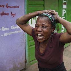 A relative wails near to the body of a man who had been shot in the head and who the crowd claimed had been shot by police, in the Mathare area of Nairobi, Kenya Wednesday, Aug. 9, 2017. Kenya's election took an ominous turn on Wednesday as violent protests erupted in the capital. (AP Photo/Ben Curtis)