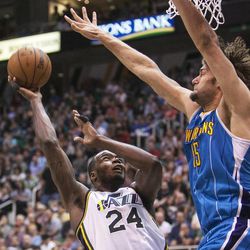 Utah's Paul Millsap puts up a shot over New Orleans' Robin Lopez as the Utah Jazz and the New Orleans Hornets play Friday, April 5, 2013 at EnergySolutions Arena in Salt Lake City. Utah won 95-83.