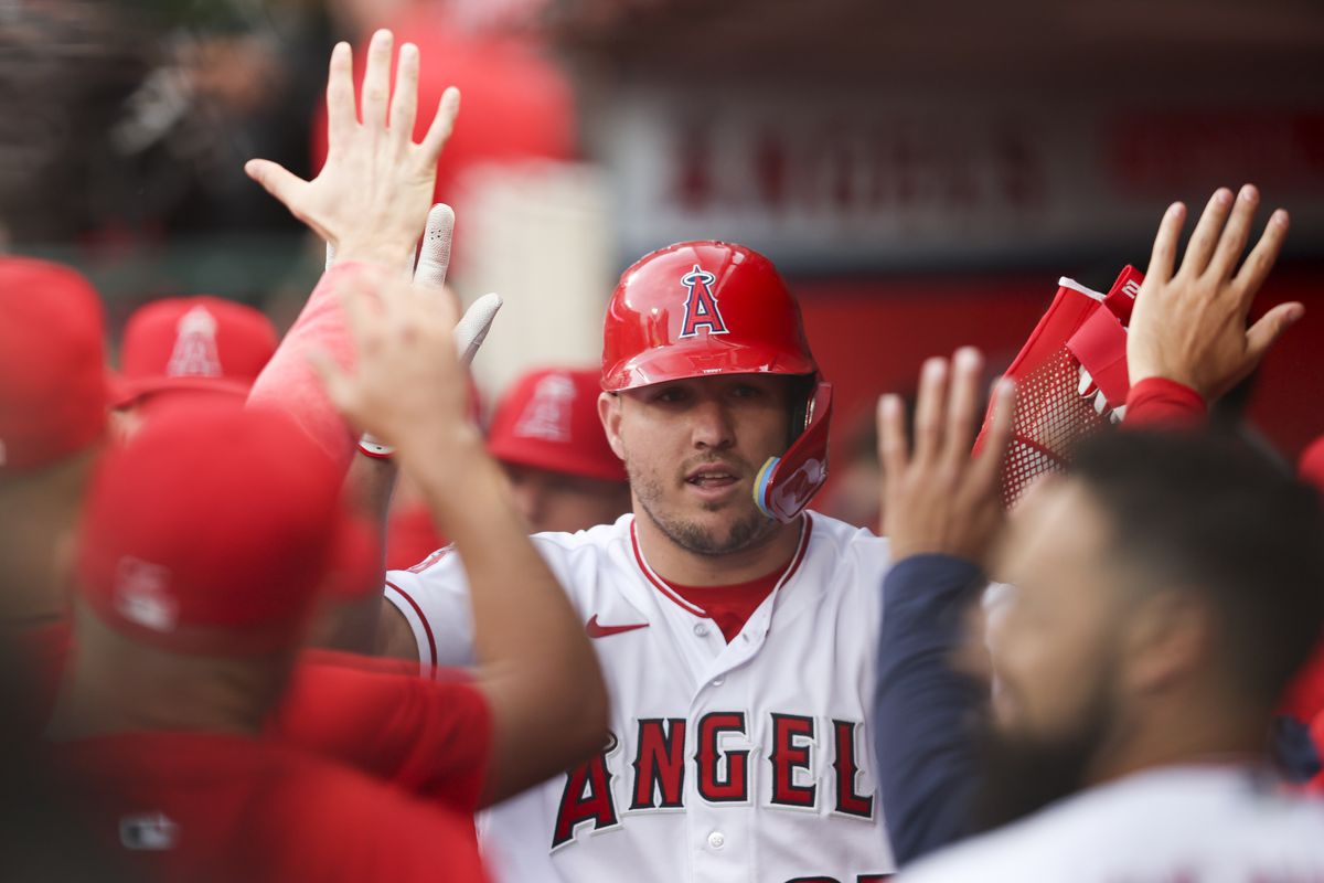 Mike Trout of the Los Angeles Angels celebrates with teammates after scoring during the first inning of a game between the Los Angeles Angels and the Oakland Athletics at Angel Stadium of Anaheim on April 25, 2023 in Anaheim, California.