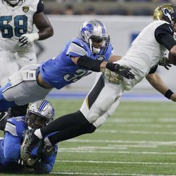 Jacksonville Jaguars quarterback Blake Bortles (5) is tackled by Detroit Lions strong safety Miles Killebrew (35) and defensive end Ezekiel Ansah (94) during the first half of an NFL football game, Sunday, Nov. 20, 2016 in Detroit. (AP Photo/Duane Burleson)