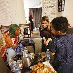 Fadumo Hussein, 45, left, talks with her friend, Pam Lang, center, and grandson, Rashed Mohammed, 4, at Hussein's home in Columbus, Ohio on Friday, Feb. 23, 2018. Hussein, a Muslim refugee from Somalia, has been separated from her elderly parents, who are in Africa and having difficulty getting to the U.S. because of President Trump's travel ban.
