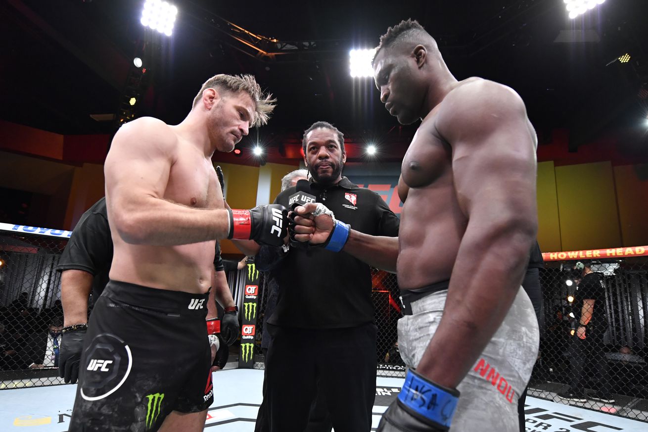 Stipe Miocic and Francis Ngannou touch gloves before the start of their title fight rematch.