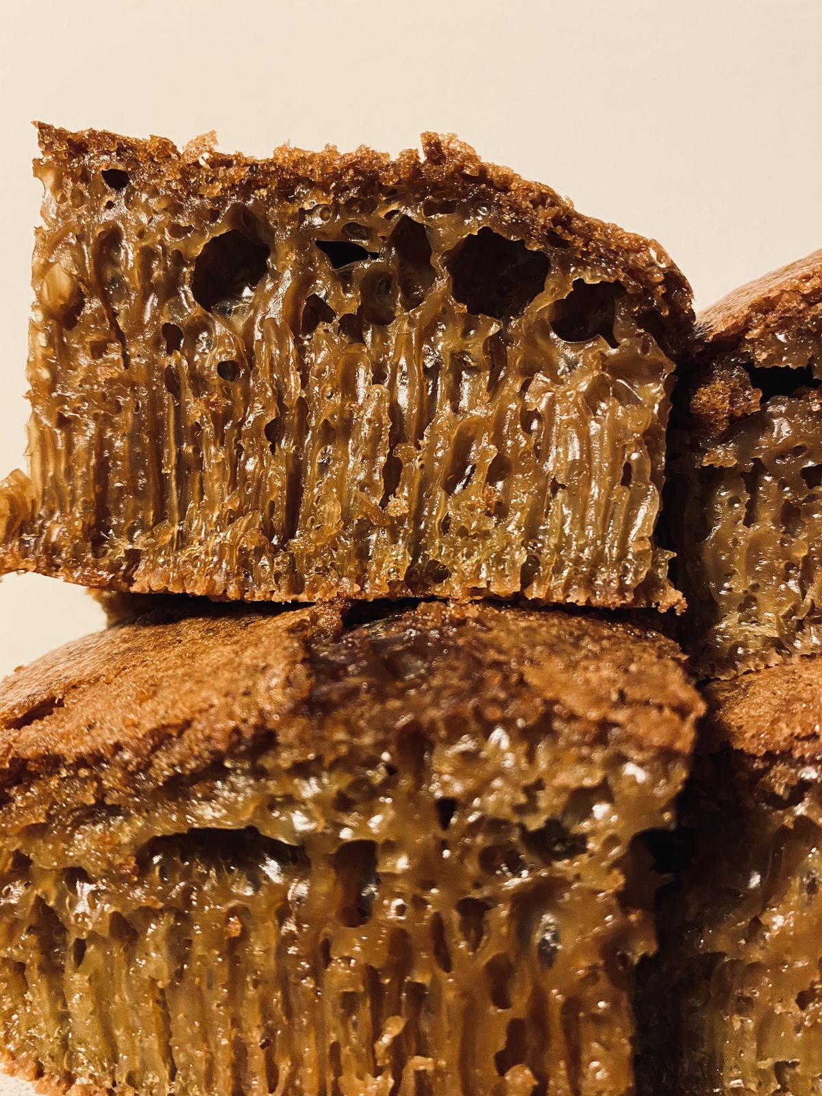 A brown cake-like bread with honey oozing out of it