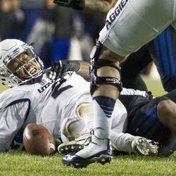 Utah State quarterback Kent Myers (2) fumbles the football during an NCAA college football game against Brigham Young in Provo on Saturday, Nov. 27, 2016. Brigham Young defeated in-state foe Utah State 28-10.