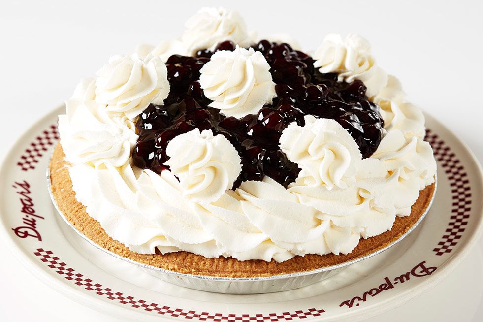 A blueberry pie with whipped cream