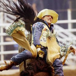 Will Lowe of Canyon Texas, does his best to hold onto Holly Time, as he rides in the final night of competition Saturday, July 25, 2015, of the Days of 47 Rodeo at EnergySolutions Arena in Salt Lake City.