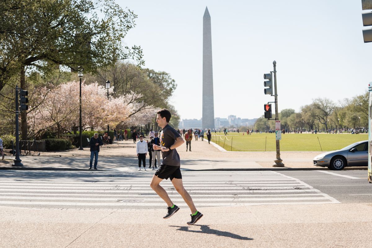 A man runs at Monument of Washington of United States on March 30, 2023.