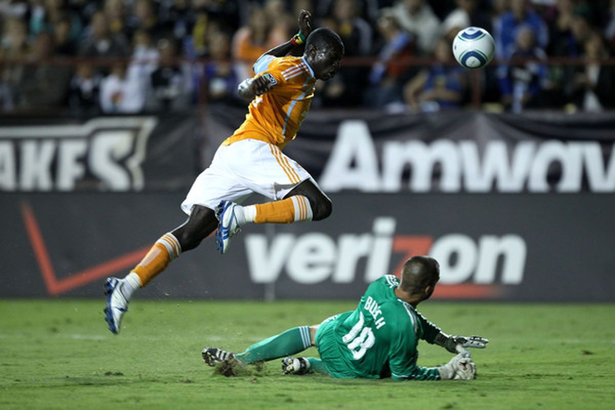 SANTA CLARA CA - OCTOBER 16:  Goalie Jon Busch #18 of the San Jose Earthquakes makes a save on a shot by Dominic Oduro #23 of the Houston Dynamo at Buck Shaw Stadium on October 16 2010 in Santa Clara California.  (Photo by Ezra Shaw/Getty Images)