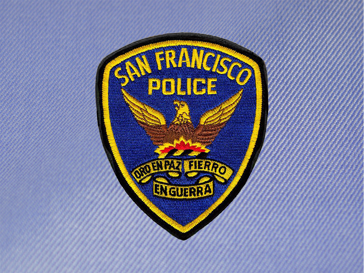 "Oro en paz, fierro en guerra" ("Gold in peace, iron in war"), reads the San Francisco Police Department's insignia.