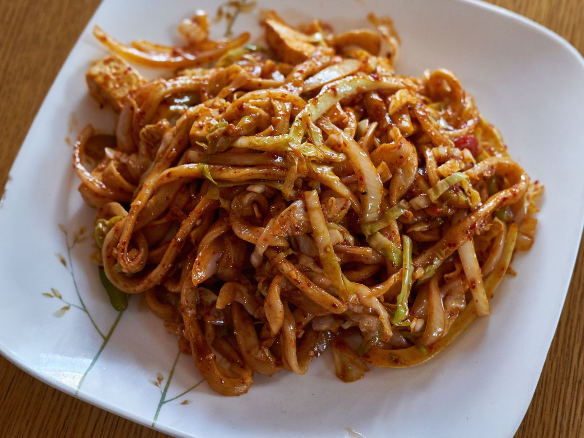 A plate of house-pulled noodles in sauce.