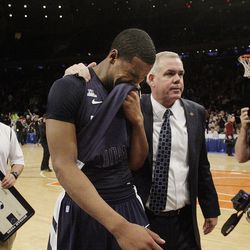 Brigham Young Cougars forward Brandon Davies (0) shows his emotions with Brigham Young Cougars head coach Dave Rose after the Cougars lost to the Baylor Bears during the NIT Final Four in New York City, Tuesday, April 2, 2013.