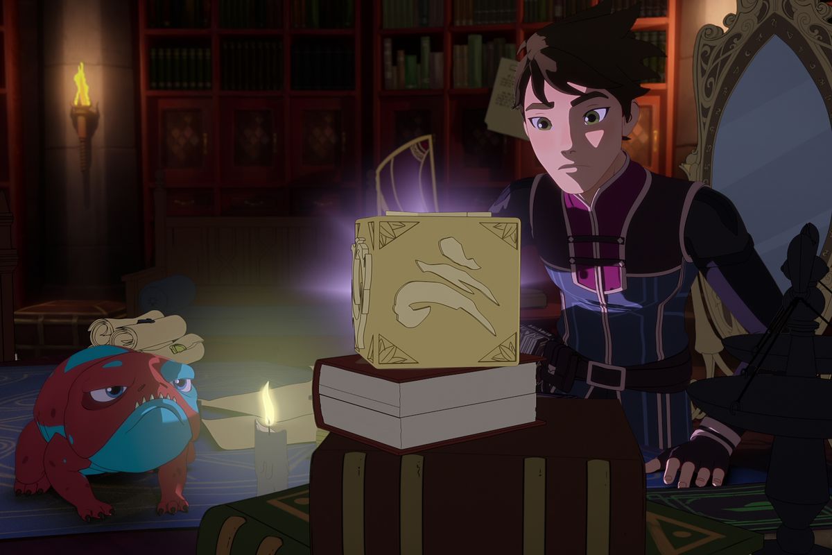 callum, a dark haired pale boy, crouches near a puzzle box with strange ruins on it; next to him, a red and blue toad creature watches, in the animated show The Dragon Prince