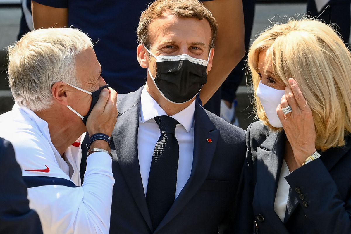 France’s coach Didier Deschamps speaks with French President Emmanuel Macron and his wife Brigitte Macron before a lunch with France’s players in Clairefontaine-en-Yvelines on June 10, 2021 ahead of the UEFA EURO 2020 football competition.