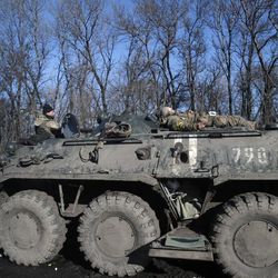 Ukrainian government troops rest atop an armored vehicle on the road towards Debaltseve near the town of Artemivsk, Ukraine, Friday, Feb. 13, 2015. The fighting between Russia-backed separatists and Ukrainian government forces has continued despite the agreement reached by leaders of Russia, Ukraine, Germany and France in the Belarusian capital of Minsk on Thursday. Much of the fighting had taken place near Debaltseve, a key transport hub that has been hotly contested in recent days. The leaders agreed to implement a cease-fire, set to take effect on Sunday, at one minute after midnight. 