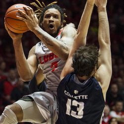 New Mexico's Jordan Goodman tries to shoot against Utah State's David Collette (13) during the second half of an NCAA college basketball game Saturday, Feb. 7, 2015, in Albuquerque, N.M. Utah State won 63-60. (AP Photo/Craig Fritz)