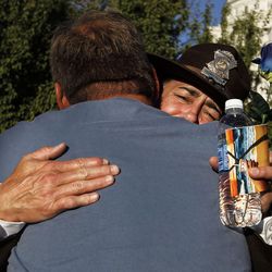 Michelle Hancock of the Utah Highway Patrol hugs David Shuman at the Utah Law Enforcement Memorial in Salt Lake City on Thursday, July 14, 2016, during a vigil to honor the Dallas police officers killed and injured in the line of duty last week.