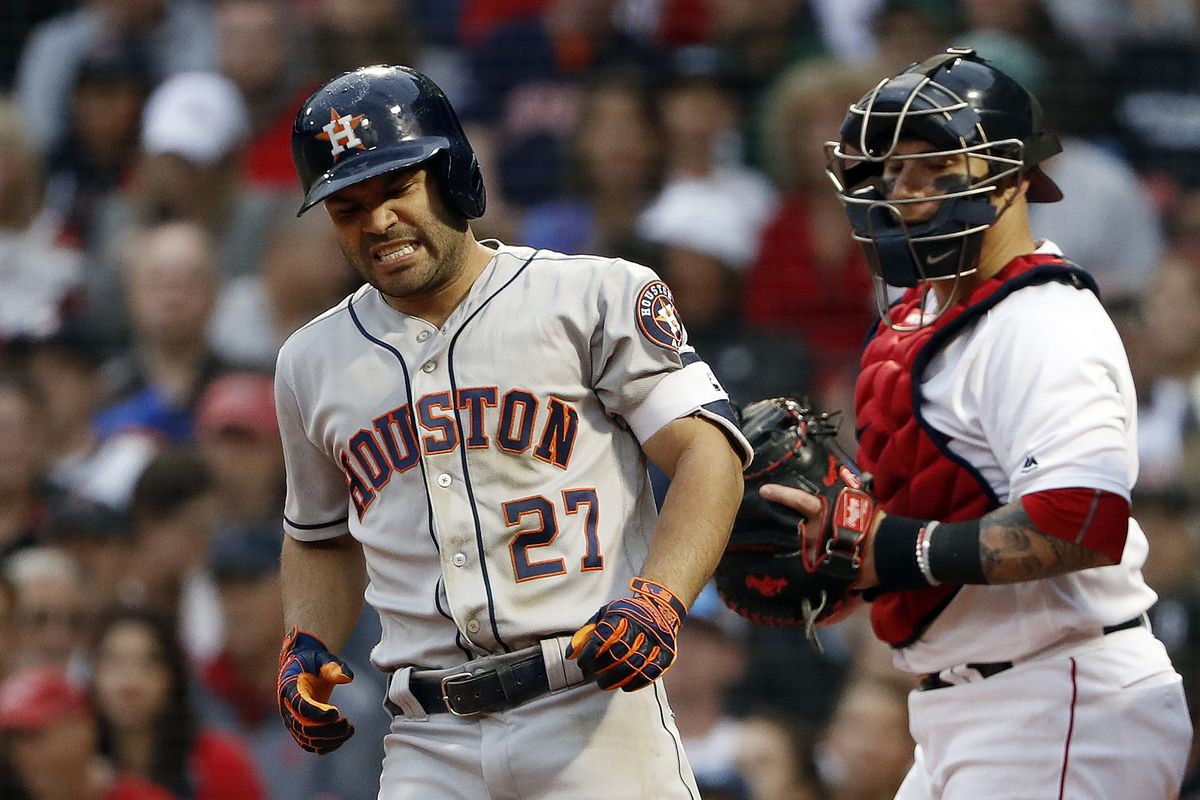 Houston Astros second baseman Jose Altuve grimaces after being hit by a pitch during the sixth inning as Boston Red Sox catcher Christian Vazquez looks on at Fenway Park.