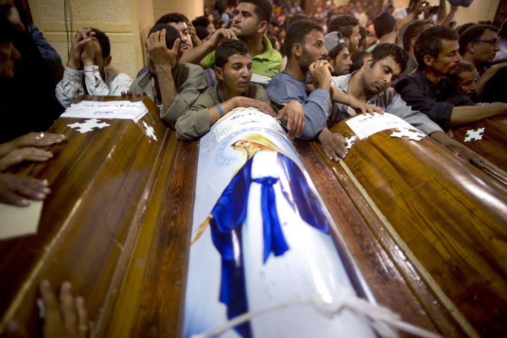 Relatives of Coptic Christians who were killed during a bus attack surround their coffins during their funeral service at Abu Garnous Cathedral in Minya, Egypt. | AP Photo