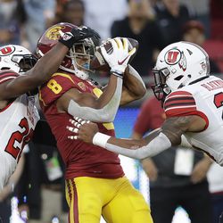 Southern California wide receiver Amon-Ra St. Brown (8) makes a touchdown catch between Utah defensive backs Javelin Guidry, left, and Julian Blackmon during the first half of an NCAA college football game Friday, Sept. 20, 2019, in Los Angeles. 