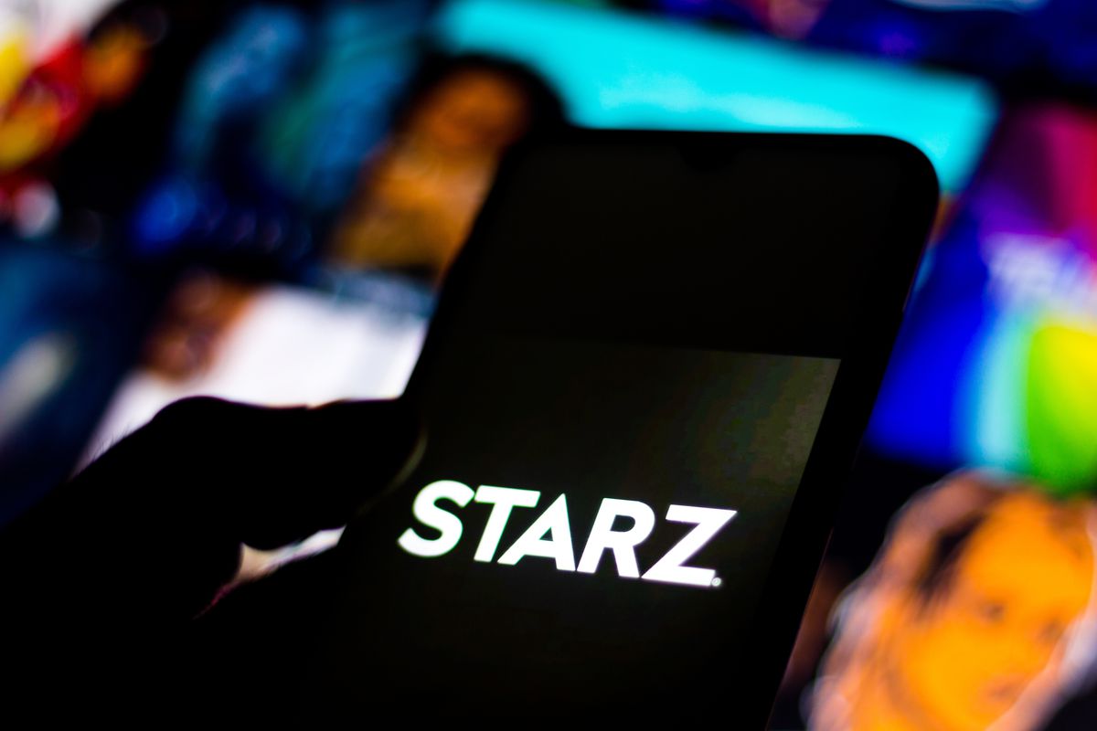 In this photo illustration the Starz logo seen displayed on...