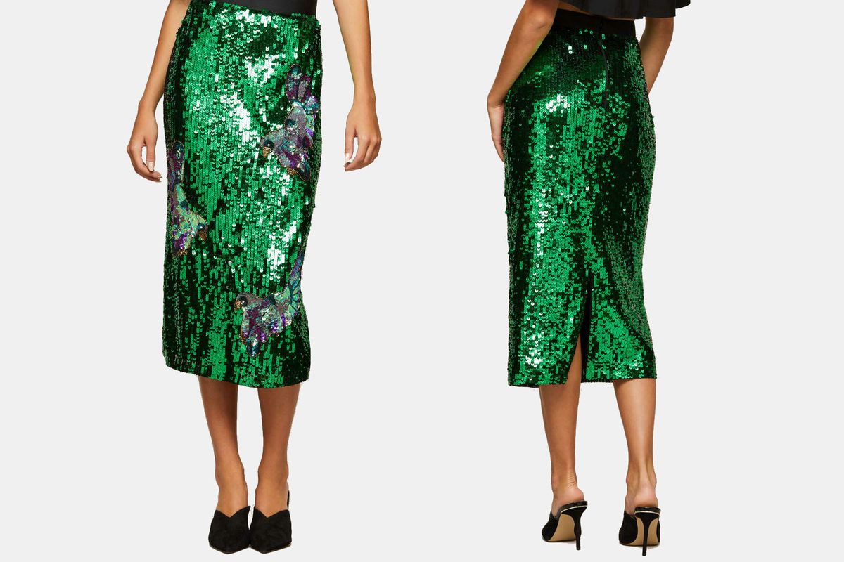 A model wearing a green sequin skirt with sequin birds on it