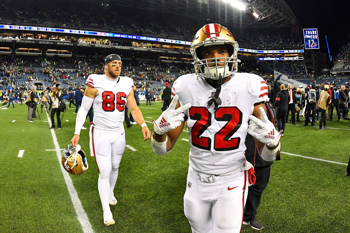 Matt Breida #22, left, and Kyle Nelson #86 of the San Francisco 49ers make their way to the locker room after the game against the Seattle Seahawks at CenturyLink Field on December 29, 2019 in Seattle, Washington. The San Francisco 49ers top the Seattle Seahawks 26-21.