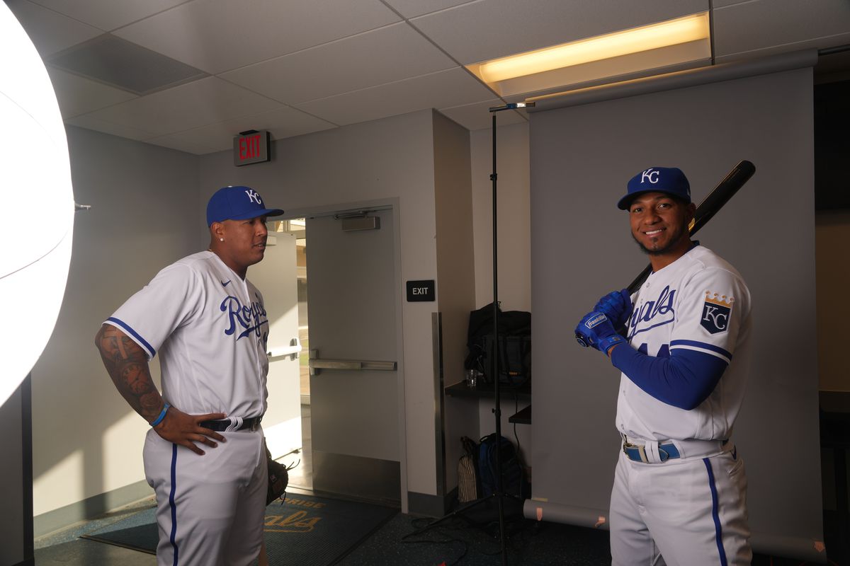 Kansas City Royals catcher Salvador Perez (13) looks on as Kansas City Royals right fielder Edward Olivares (14) poses for a photo during Photo Day at Surprise Stadium