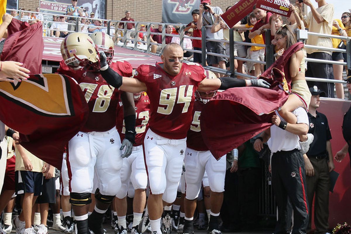 Mark Herzlich #94 and Thomas Claiborne #78 of the Boston College Eagles lead the team out on the field.  (Photo by Elsa/Getty Images)