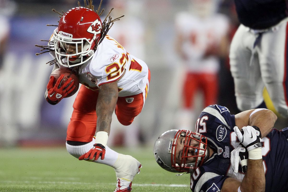 FOXBORO, MA - NOVEMBER 21:  Dexter McCluster #22 of the Kansas City Chiefs tries to avoid  Rob Ninkovich #50 of the New England Patriots on November 21, 2011 at Gillette Stadium in Foxboro, Massachusetts.  (Photo by Elsa/Getty Images)
