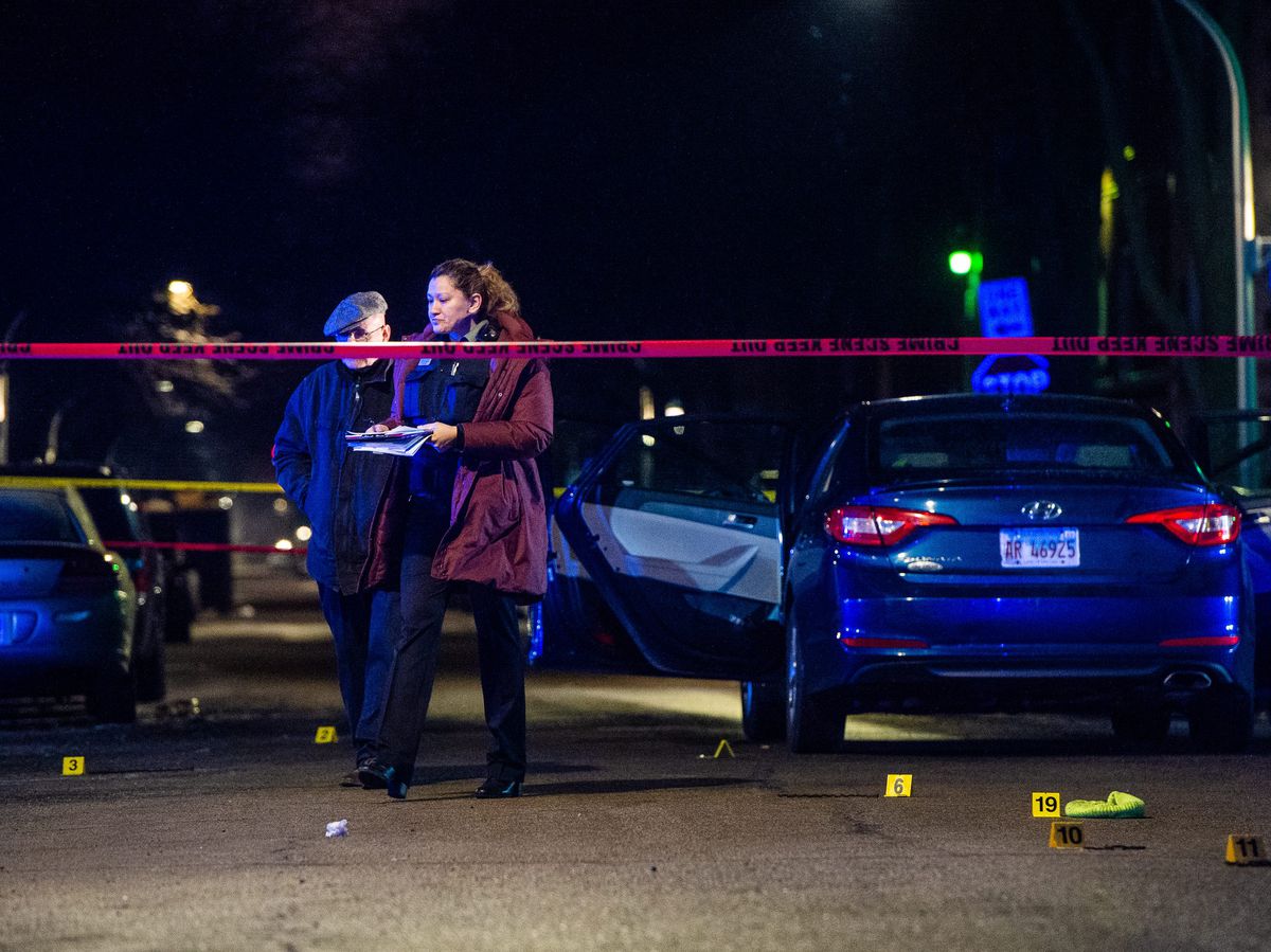 Police investigate the scene where a 25-year-old man was shot and killed during a street brawl, Saturday morning, in the first block of South Lavergne, in the Austin neighborhood. | Tyler LaRiviere/Sun-Times