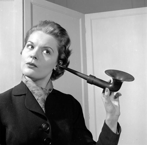 Woman uses old-fashioned ear trumpet