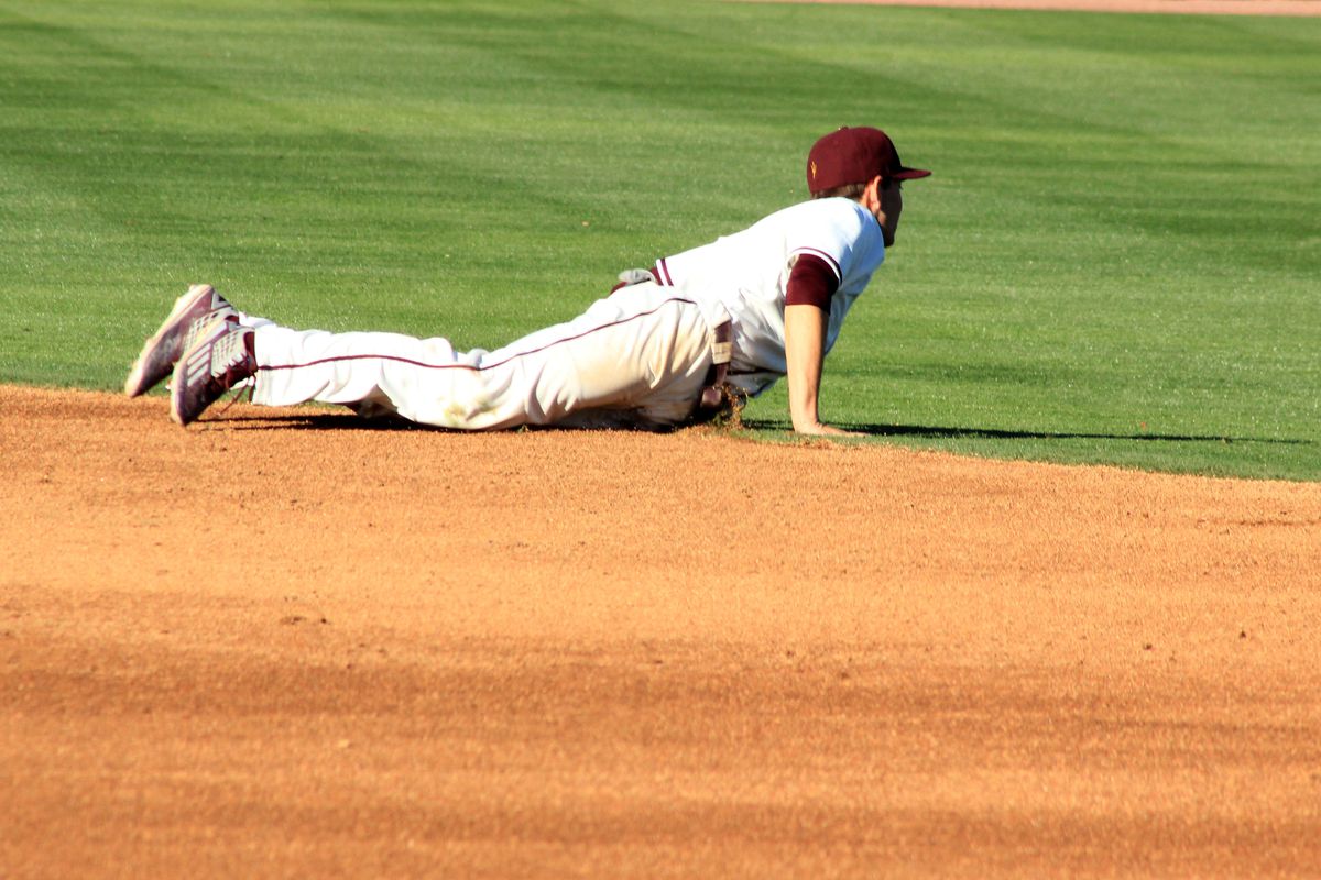 Andrew Snow dives for a ground ball against Xavier on February 20 