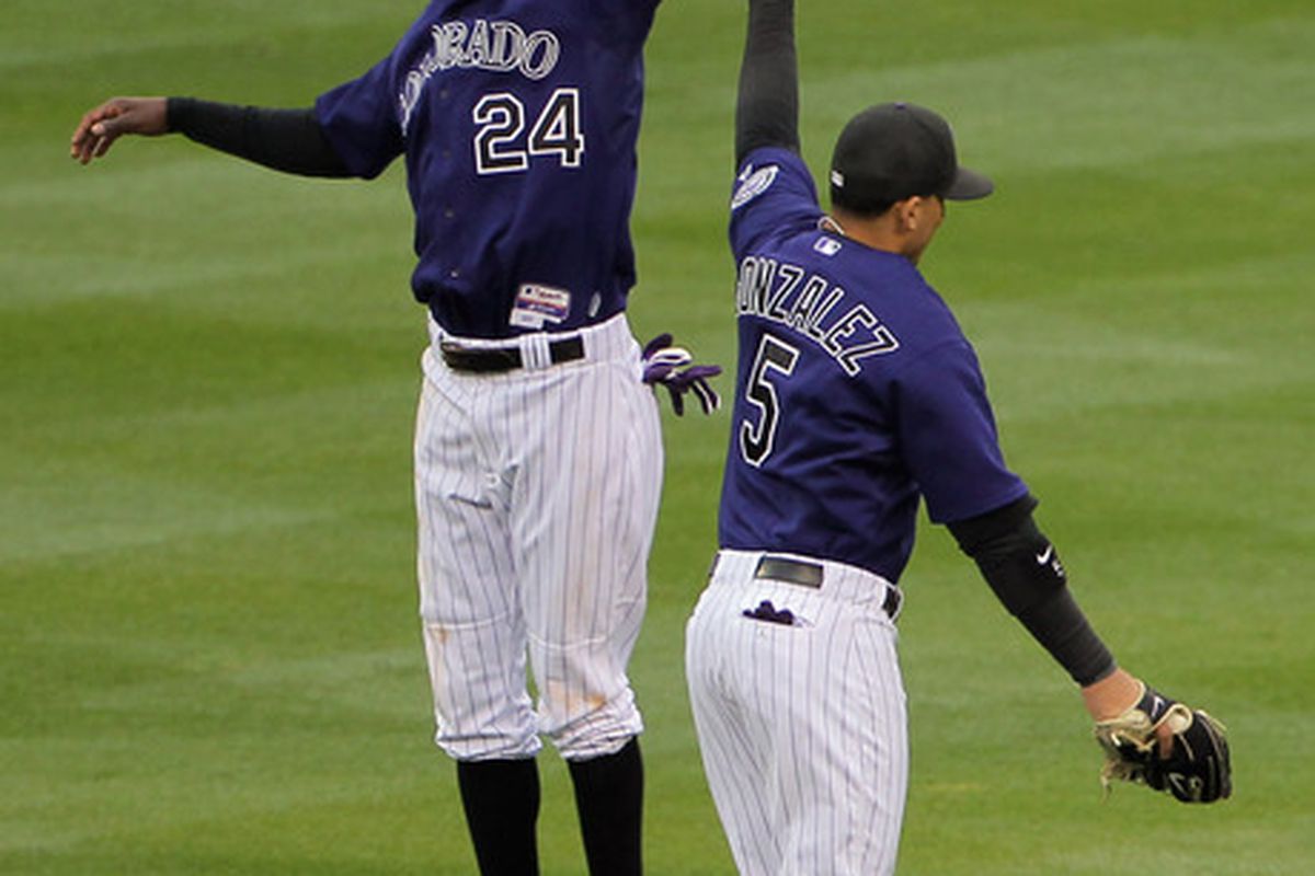 DENVER, CO - APRIL 20:  Dexter Fowler #24 and Carlos Gonzalez #5 of the Colorado Rockies celebrate their 10-2 victory over the San Francisco Giants at Coors Field on April 20, 2011 in Denver, Colorado.  (Photo by Doug Pensinger/Getty Images)