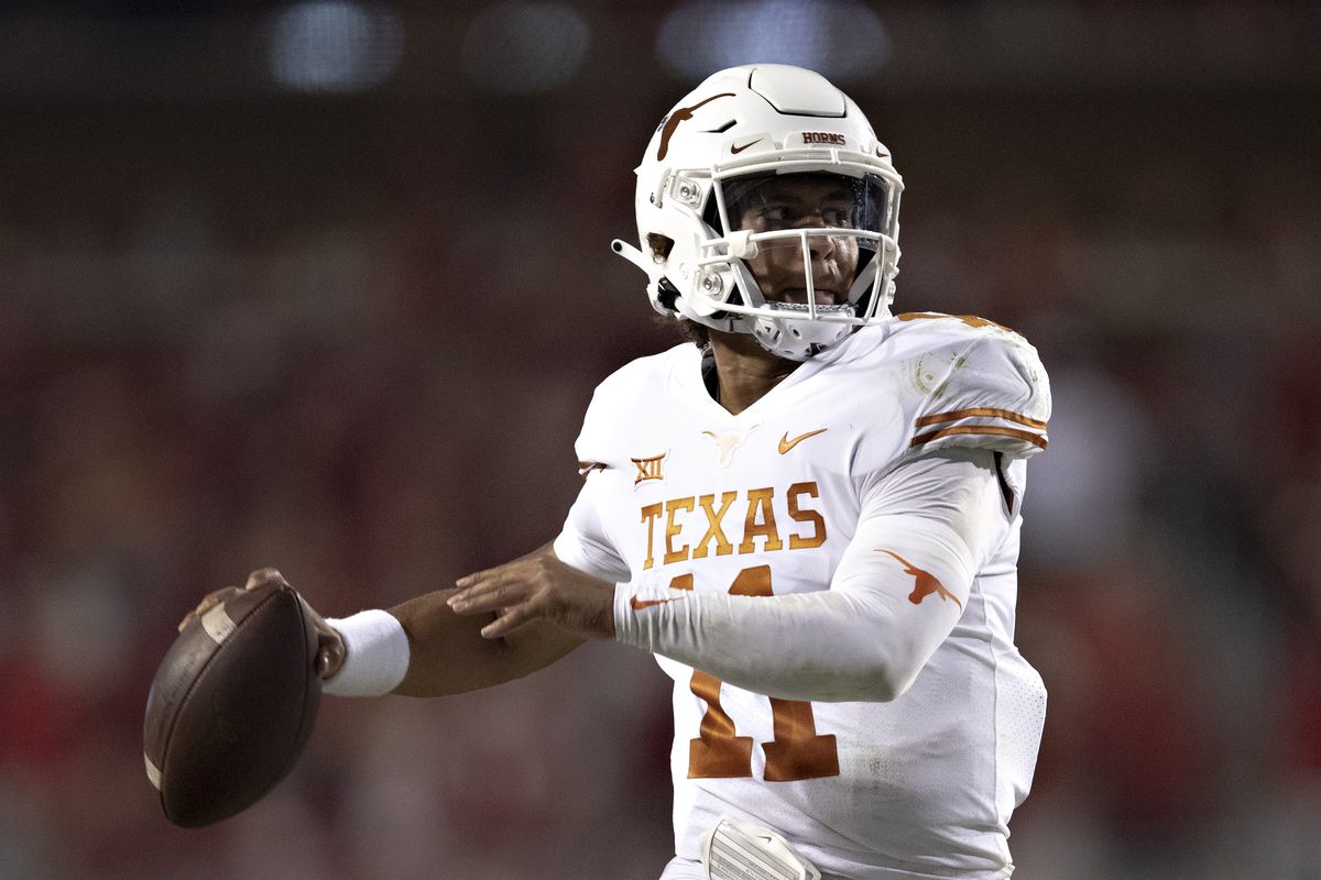 Casey Thompson of the Texas Longhorns rolls out to throw a pass in the second half of a game against the Arkansas Razorbacks at Donald W. Reynolds Razorback Stadium on September 11, 2021 in Fayetteville, Arkansas.