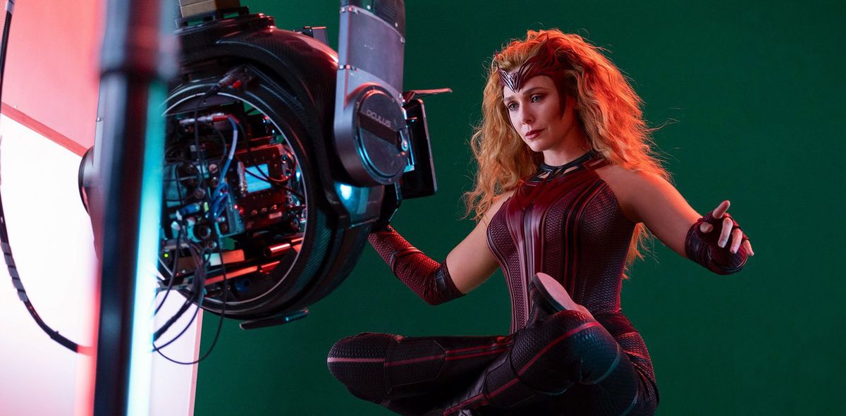 Elizabeth Olsen as Wanda on the set of Wandavision floating in front of a green screen and behind a camera rig