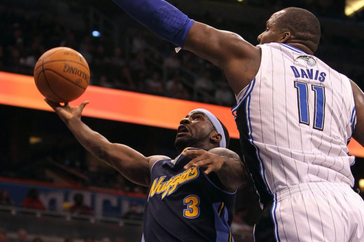 April 1, 2012; Orlando FL, USA; Denver Nuggets point guard Ty Lawson (3) shoots as Orlando Magic power forward Glen Davis (11) defends during the first half at Amway Center. Mandatory Credit: Kim Klement-US PRESSWIRE