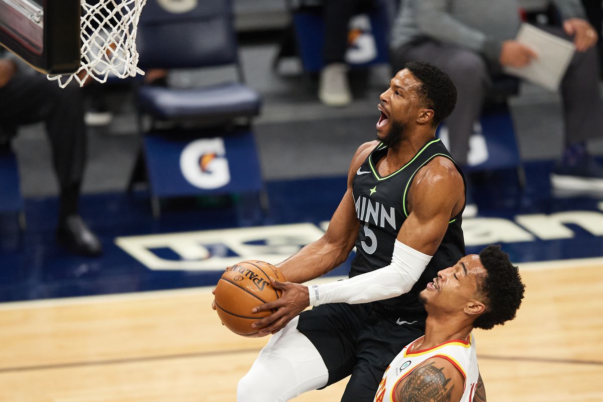 Malik Beasley of the Minnesota Timberwolves shoots the ball against John Collins of the Atlanta Hawks during the game at Target Center on January 22, 2021 in Minneapolis, Minnesota. The Hawks defeated the Timberwolves 116-98.&nbsp;