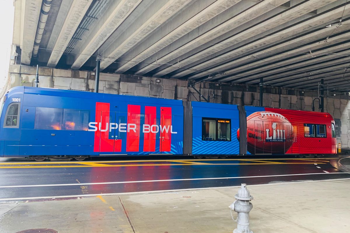 A picture of the streetcar covered in a Super Bowl wrap