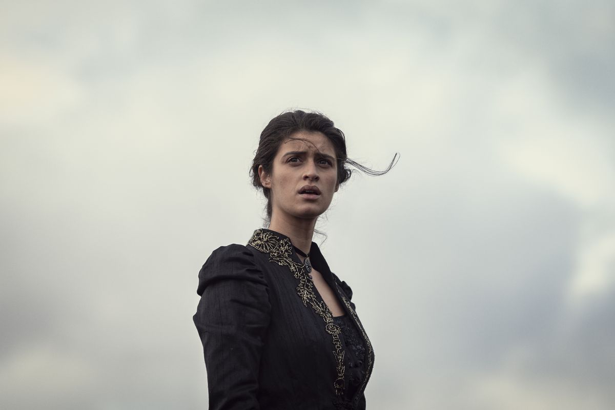 Yennefer standing against a gray sky in a still from season 2 of The Witcher
