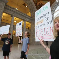 Nancy Ballard holds a sign as protesters gather at the Capitol rotunda in Salt Lake City Wednesday, June 19, 2013, to protest what they believe is corruption in the Utah Attorney General’s Office.