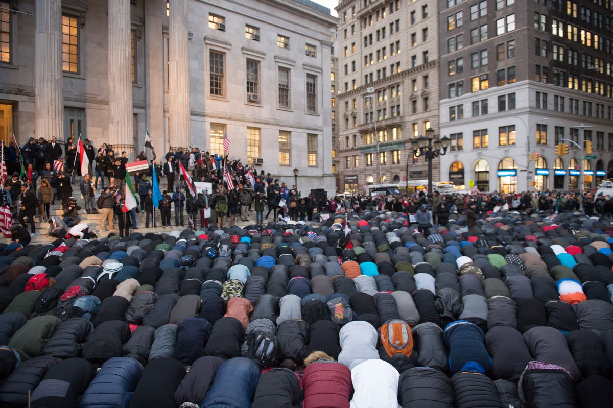 Yemeni-Americans pray during their protest against the immigration ban