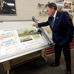 Gov. Gary Herbert looks at a student's proposal for the new Davis Applied Technology Center medical building while touring the facility in Kaysville on Wednesday, Dec. 13, 2017.  Herbert unveiled his $16.7 billion budget proposal at the center and declared 2018 as the “Year of Technical Education.”