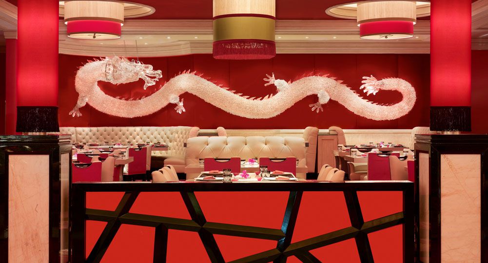 Restaurant interior centered around white dragon wall hanging