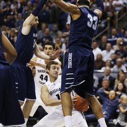 Brigham Young Cougars guard Chase Fischer (1) drives on San Diego Toreros center Jito Kok (33) in Provo Thursday, Feb. 19, 2015. 